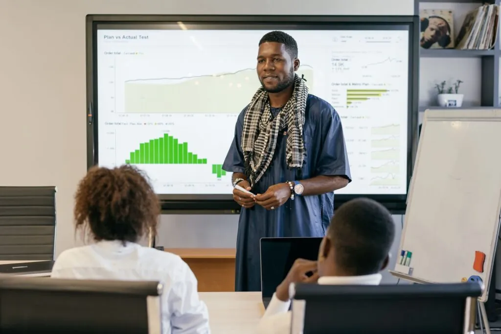Consultant presenting business results to a team in a meeting room